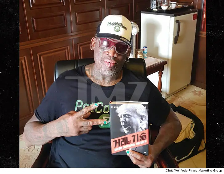 Dennis Rodman with Donald Trump's book